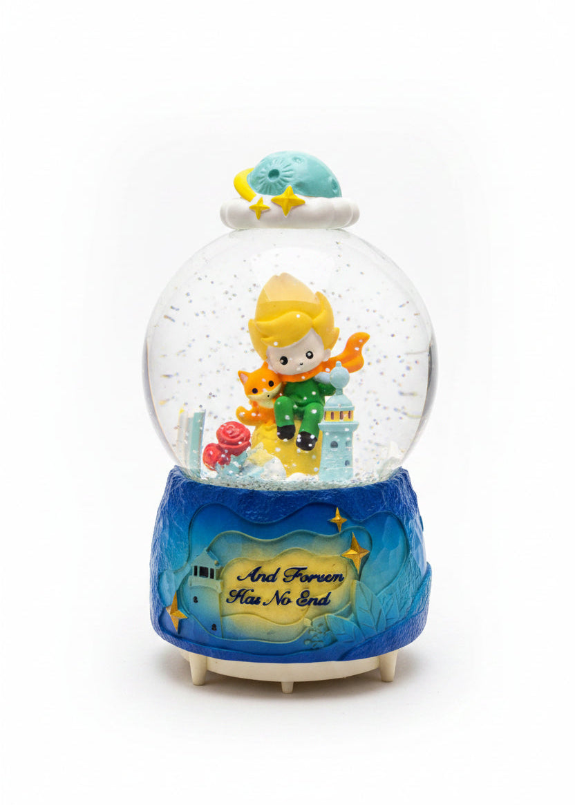 A decorative snow globe figurine with a blue base, featuring a small character in a yellow hat and green coat holding a red flower, inside a clear globe with glitter and a cloud-and-moon topper. The base reads 'Mr.