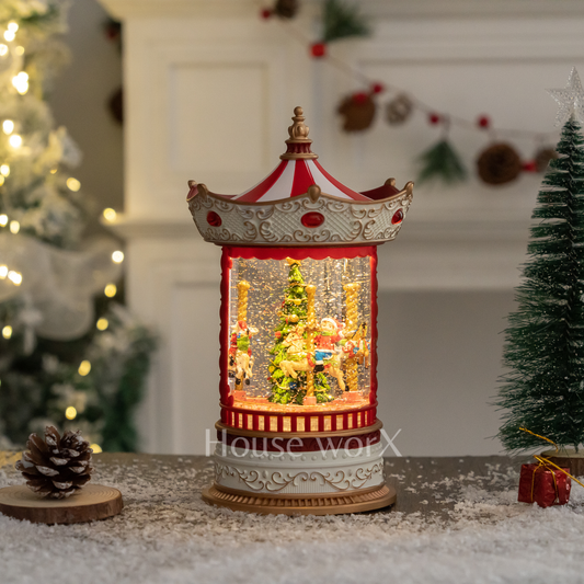 Decorative Merry go round snow globewith lights and figures in a festive setting with Christmas trees and decorations.
