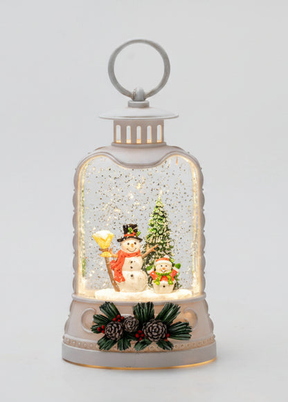 Decorative snow globe with a snowman and Christmas tree inside, on a light gray background.