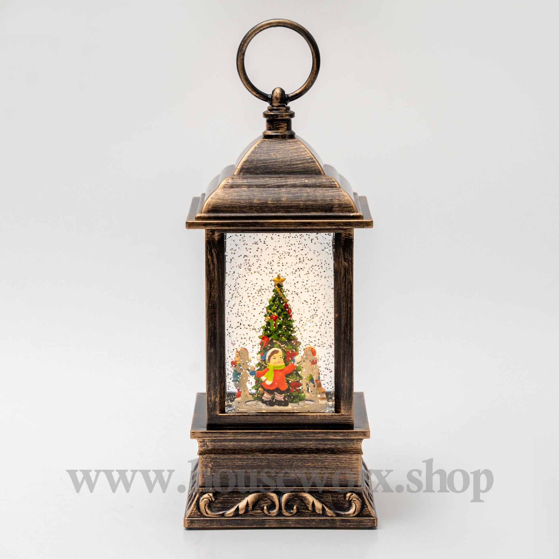 Decorative lantern with a Christmas scene inside on a white background 360 degree rotating children around tree christmas snw globe