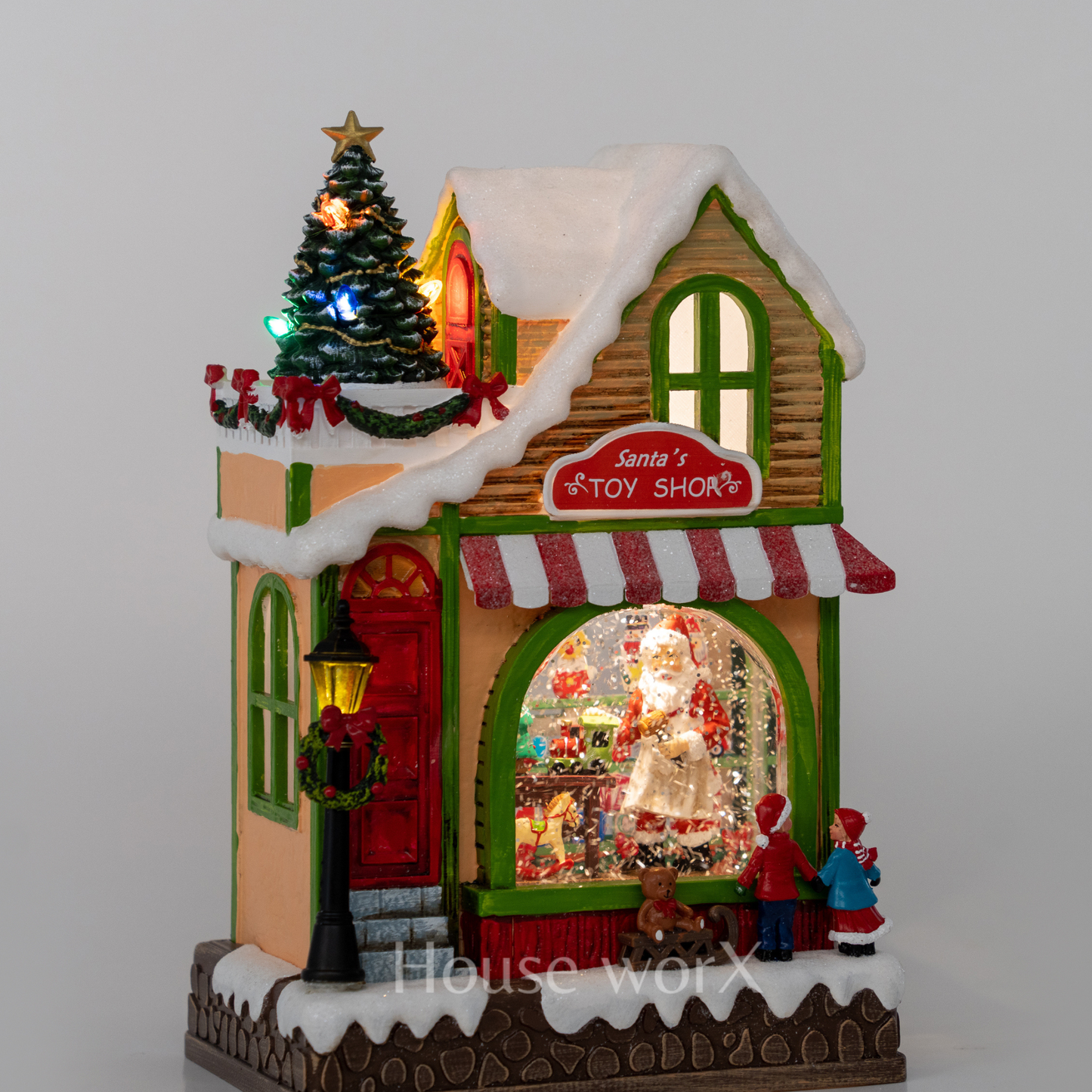 Decorative Christmas house with a tree and Santa Claus figure Snow Globe