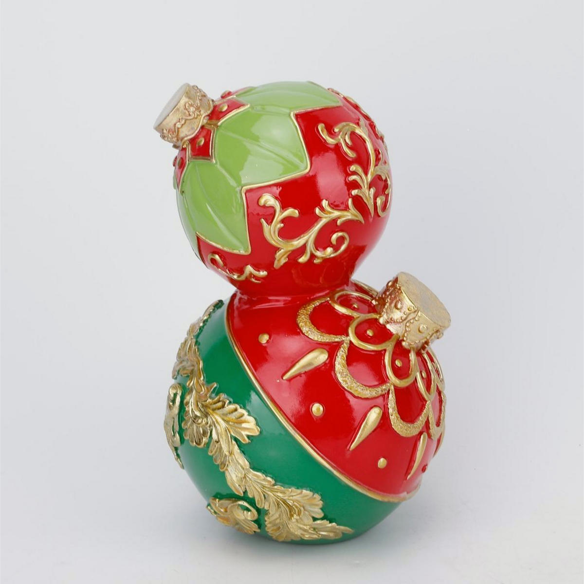 A decorative two-tiered gourd ornament with a glossy red and green pattern, accented with raised gold floral details and small gold caps at the top and bottom, shown on a light gray background.