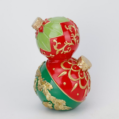 A decorative two-tiered gourd ornament with a glossy red and green pattern, accented with raised gold floral details and small gold caps at the top and bottom, shown on a light gray background.