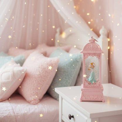 A pink decorative lantern-shaped ornament featuring a small figurine of Cinderella in a blue dress inside, 