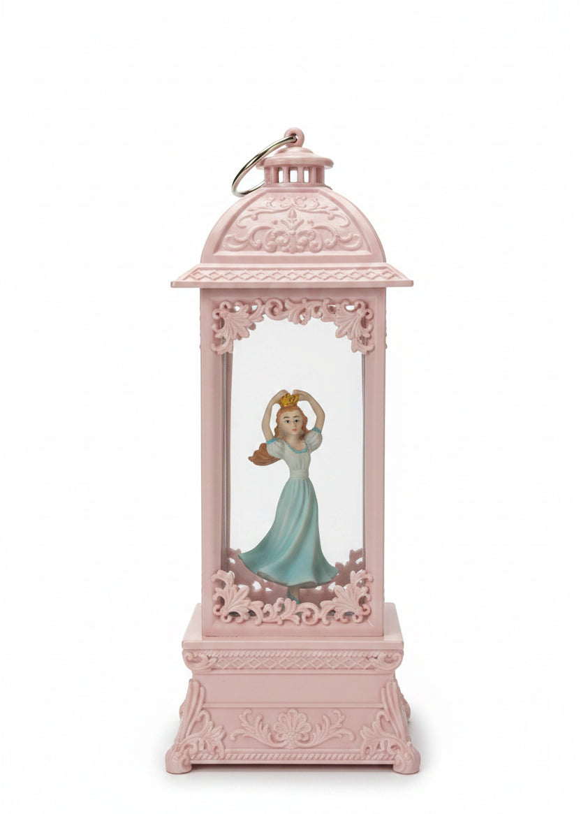 A pink decorative lantern-shaped ornament featuring a small figurine of Cinderella in a blue dress inside