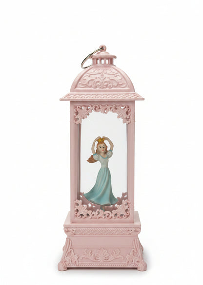 A pink decorative lantern-shaped ornament featuring a small figurine of Cinderella in a blue dress inside