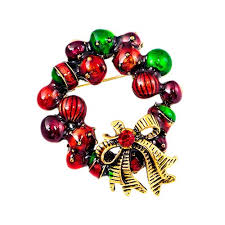 Colorful beaded brooch with a gold bow charm on a white background