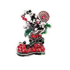 Decorative figurine of a bear in a boot with candy canes and red berries on a white background