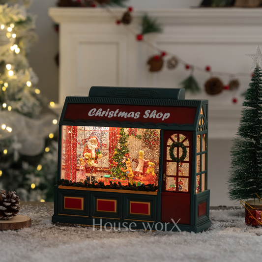 Decorative Christmas shop snow globe light box with Santa Claus scene in a festive setting.