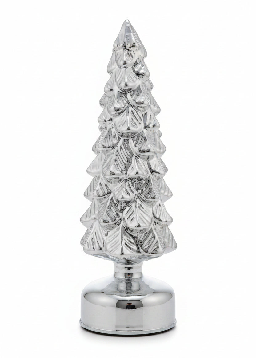 A small metallic silver Christmas tree figurine with a textured, glittery finish and a round base
