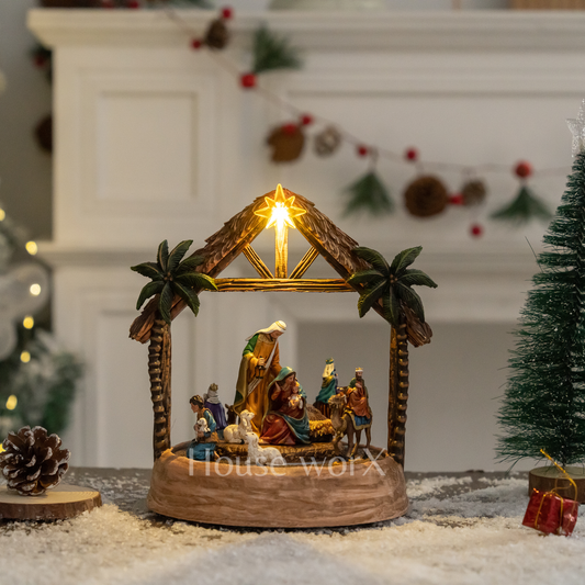 Decorative nativity scene with illuminated star on a snowy base, 