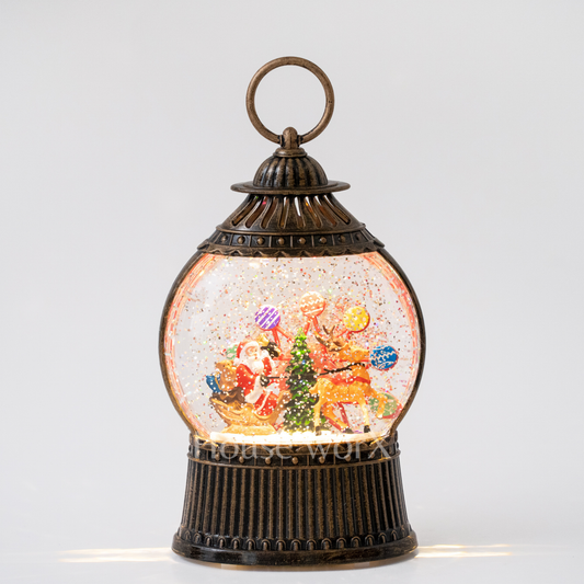 Decorative snow globe with a festive scene inside on a white background