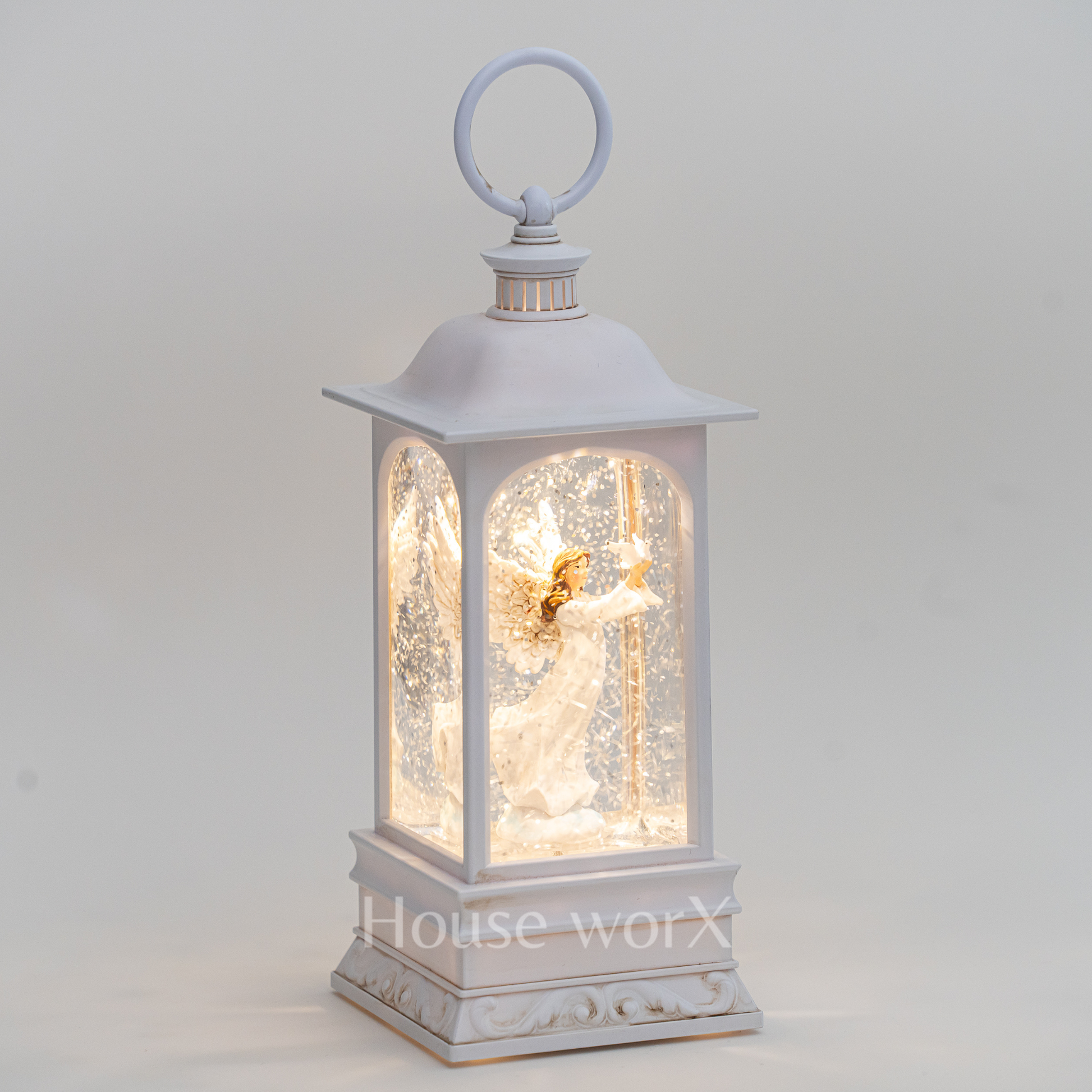 Decorative lantern with an angel figure inside on a light gray background