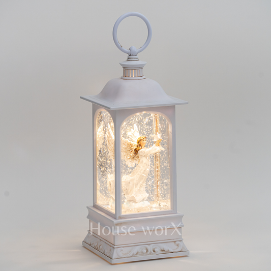 Decorative lantern with an angel figure inside on a light gray background