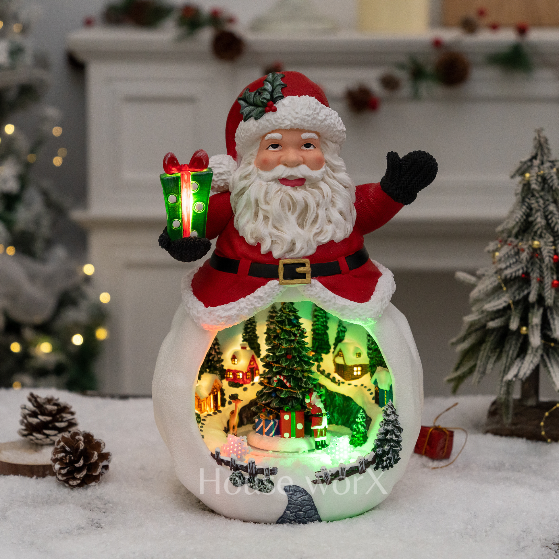 Decorative Christmas scene with Santa Claus figure inside a glowing village
