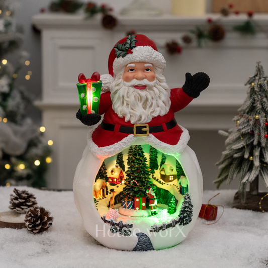 Decorative Christmas scene with Santa Claus figure inside a glowing village