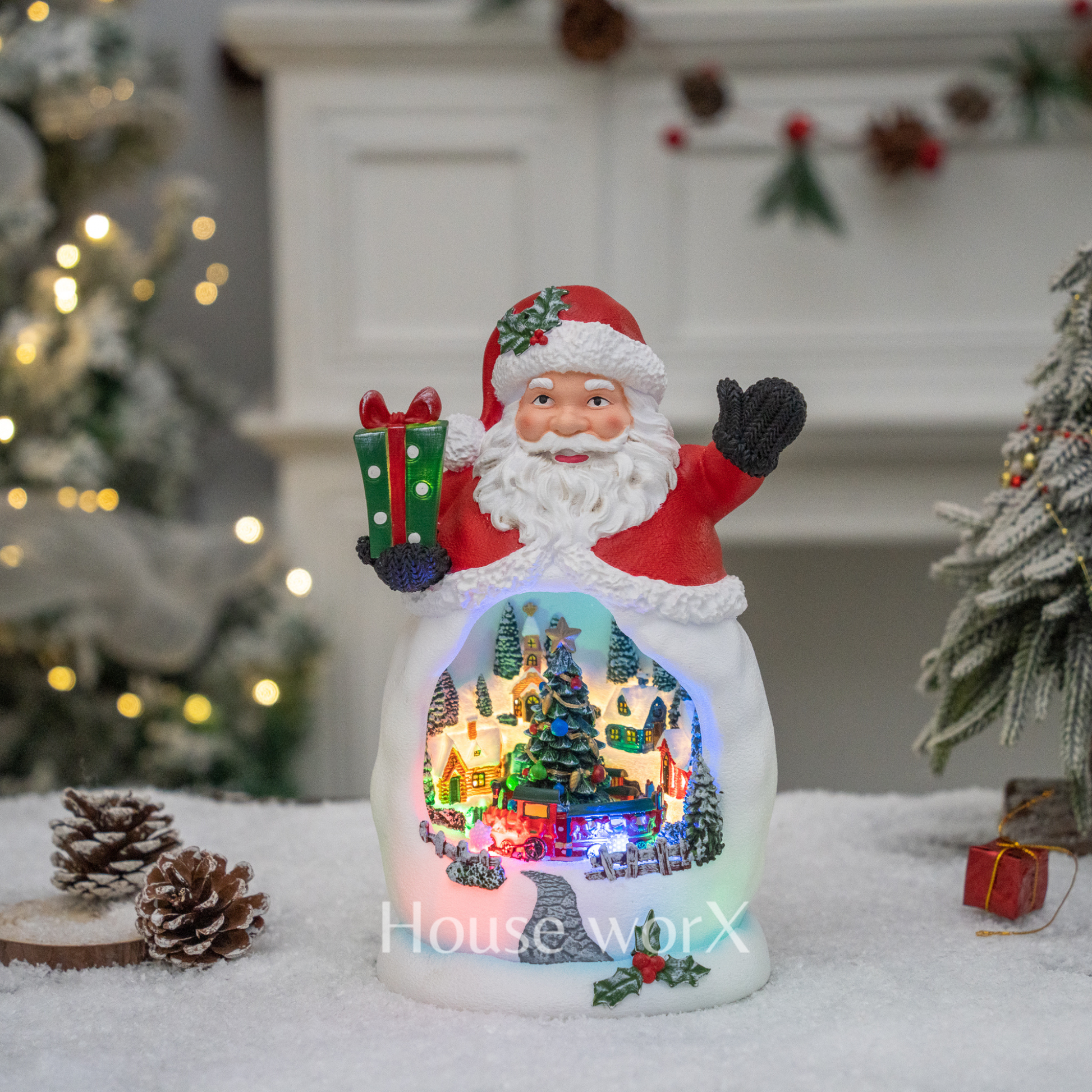 Decorative Christmas snow globe with Santa Claus figure and lit scene inside, placed on a snowy surface.
