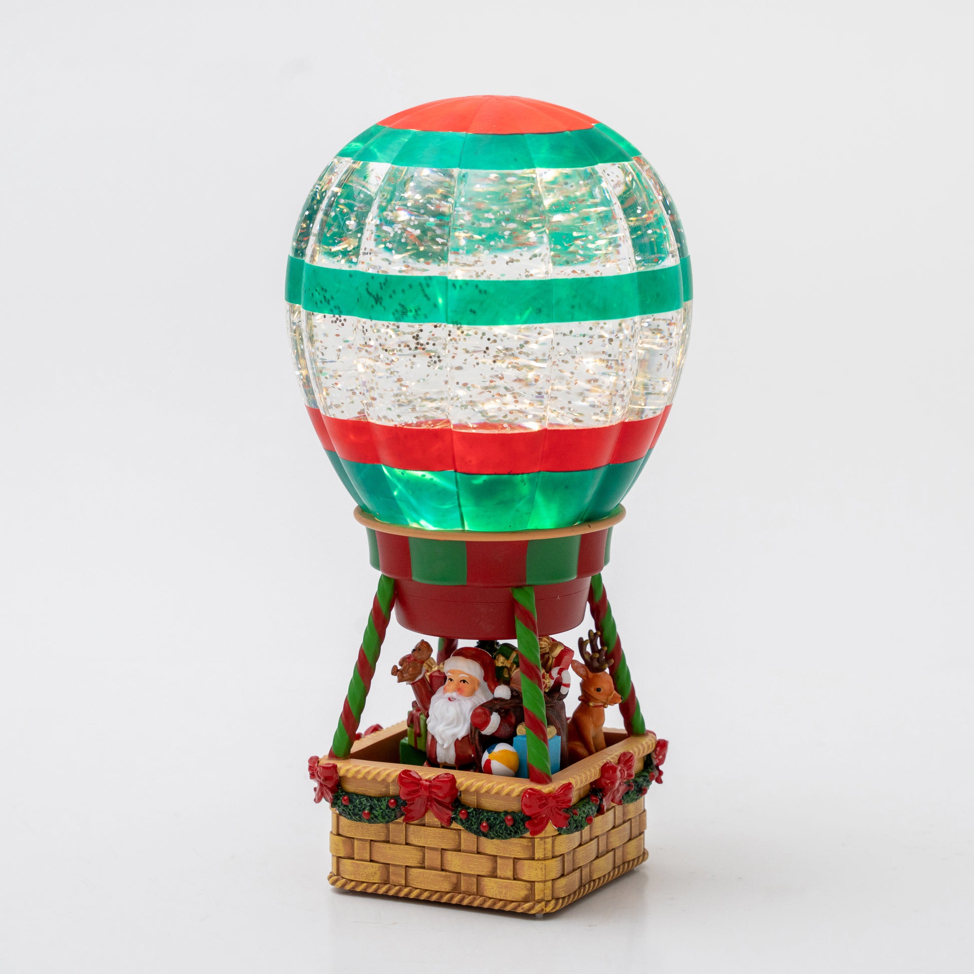 Decorative hot air balloon with Santa Claus and reindeer on a white background Christmas snow globe