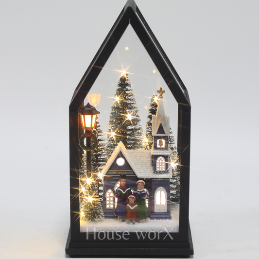 Decorative display with a house, tree, and people in a black house-shaped frame on a white background.