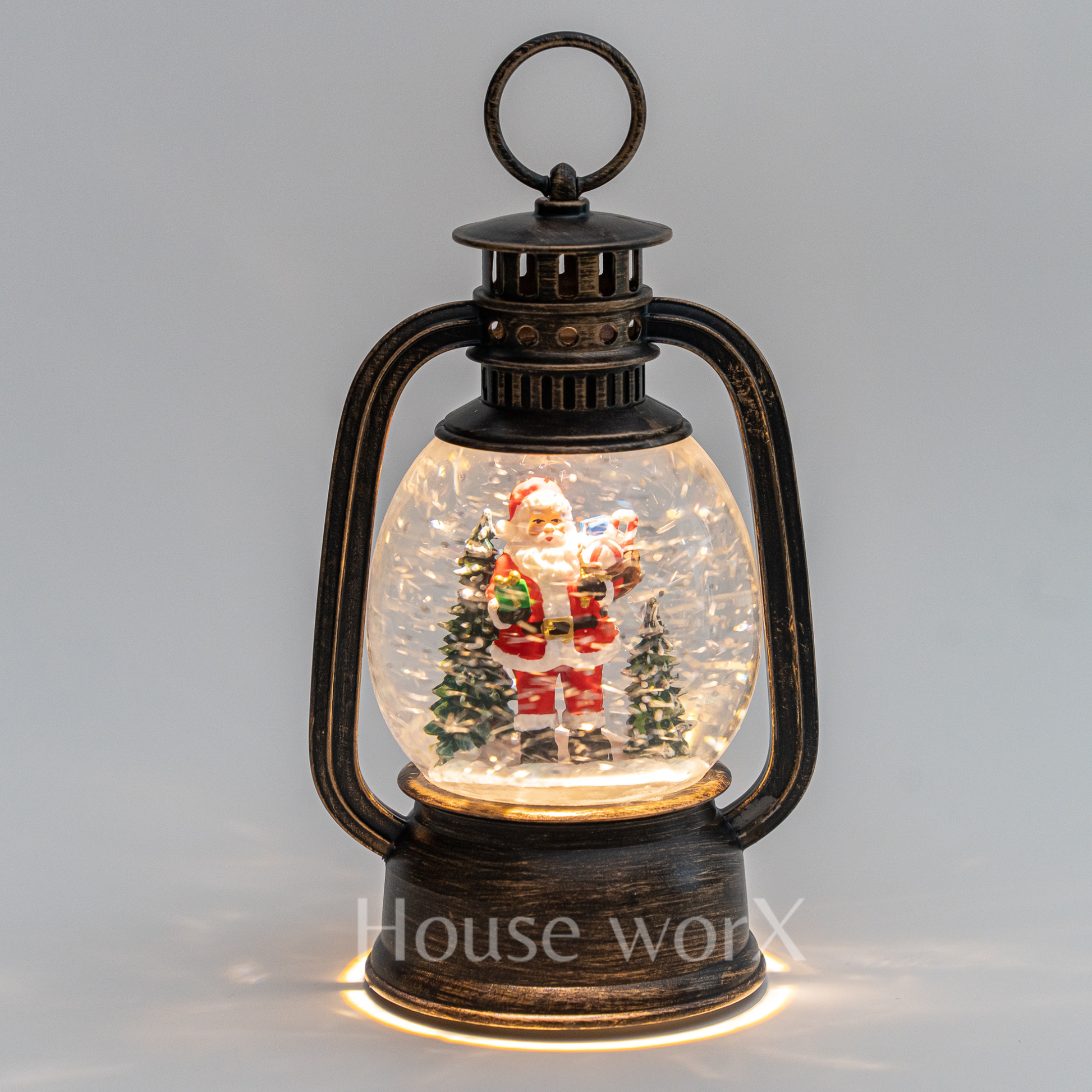 Decorative lantern with a Santa Claus figure inside a snow globe on a gray background
