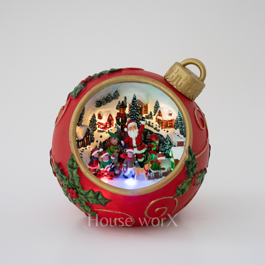 Decorative Christmas ornament with a scene of Santa Claus and children, featuring intricate details and a gold top.