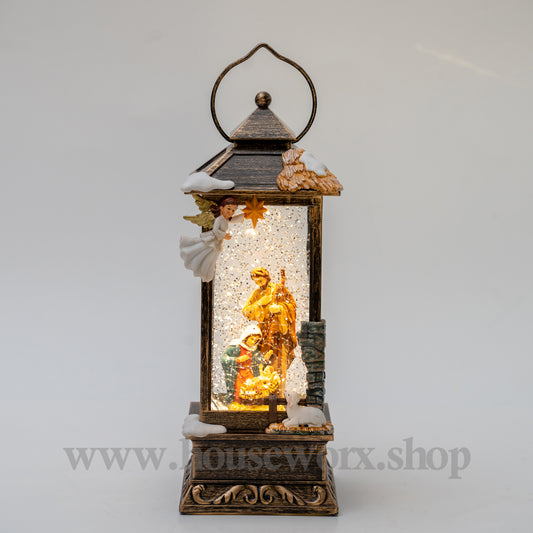 Decorative lantern with a nativity scene inside on a white background Christmas snow globe