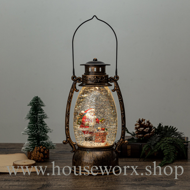 Decorative lantern with a santa inside on a wooden surface, featuring the brand 'houseworx'.