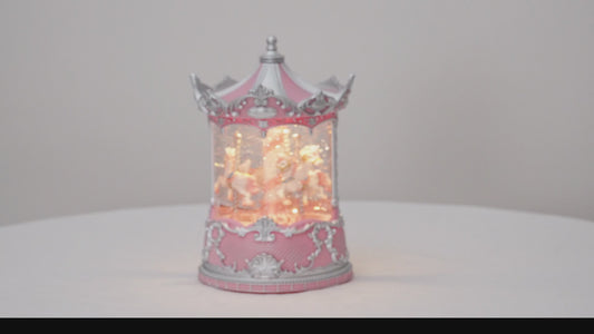 Decorative carousel with pink and silver design on a white background snow globe vdeo
