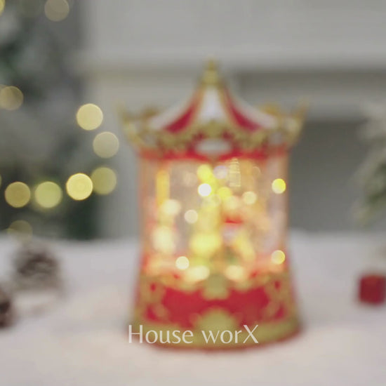 Decorative Christmas Snow Globe carousel with lights on a snowy surface, featuring 'House of Worx' branding. video