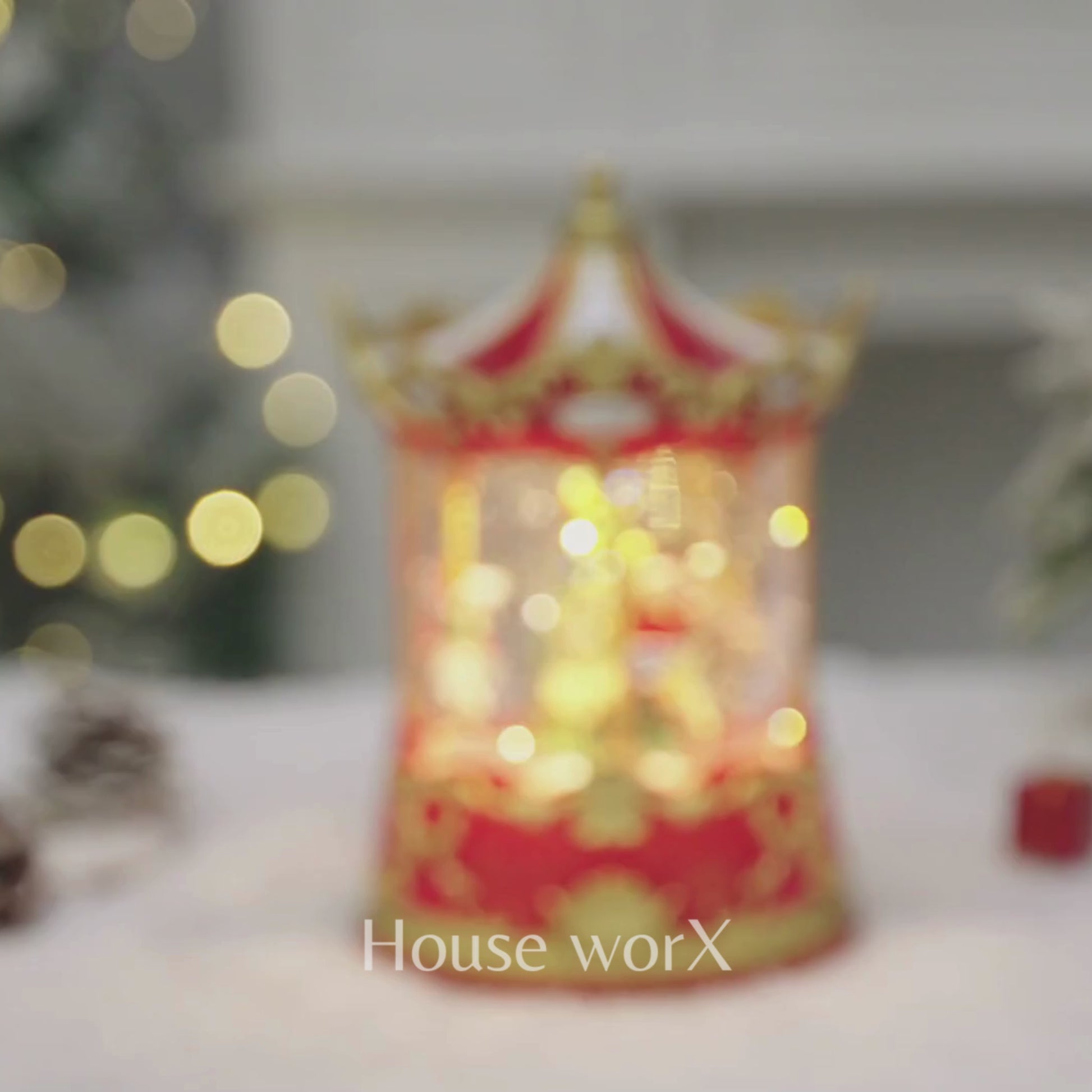 Decorative Christmas Snow Globe carousel with lights on a snowy surface, featuring 'House of Worx' branding. video
