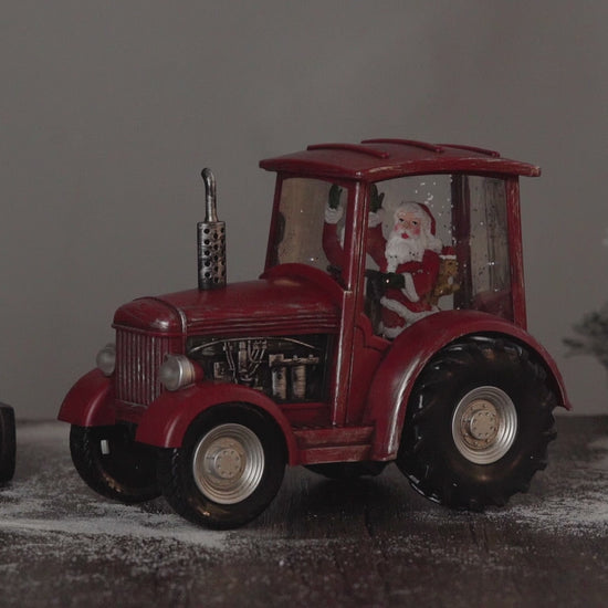 red tractor christmas snow globe video