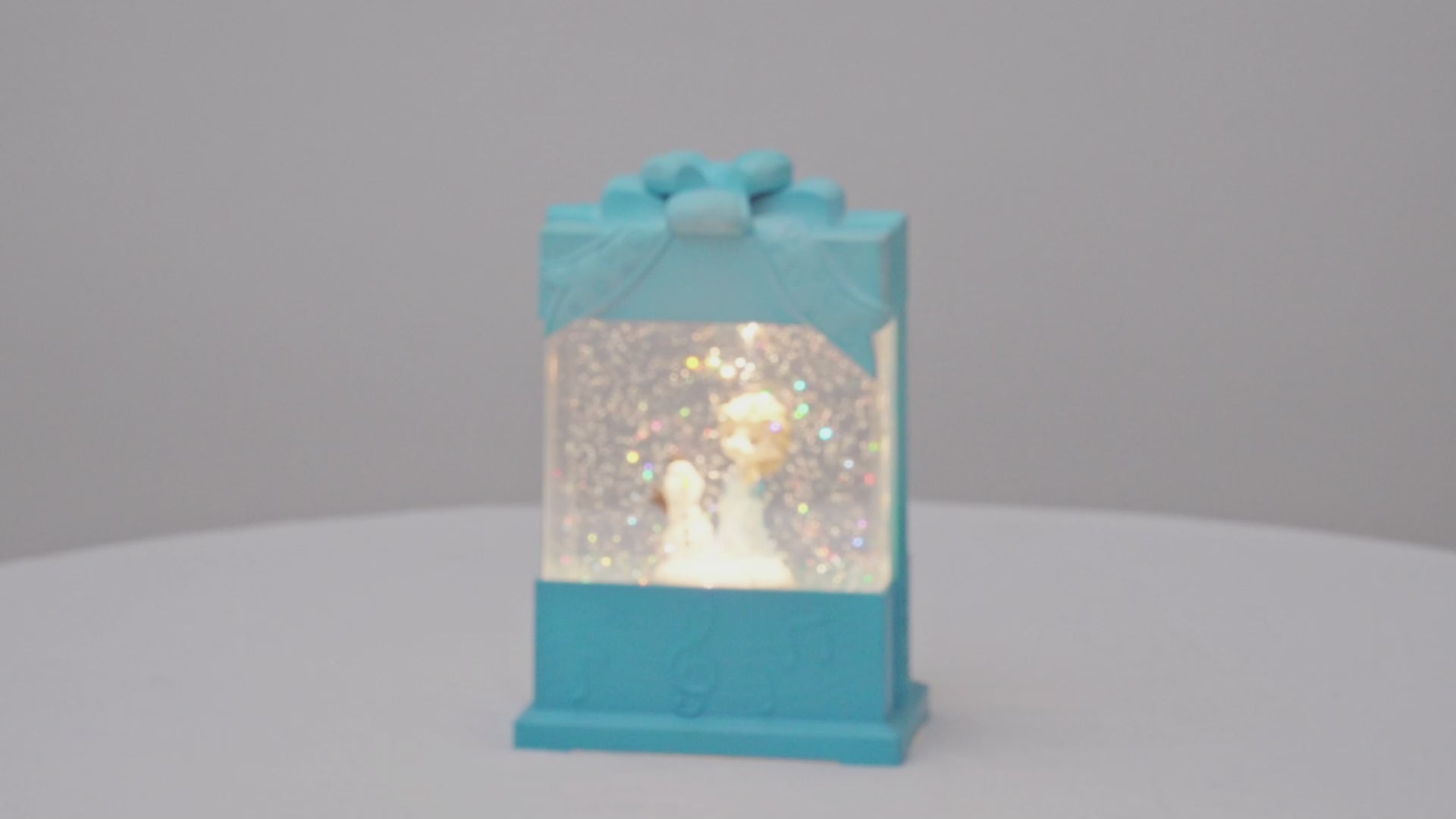 Decorative snow globe present shape with characters inside, featuring 'House worX' branding. video