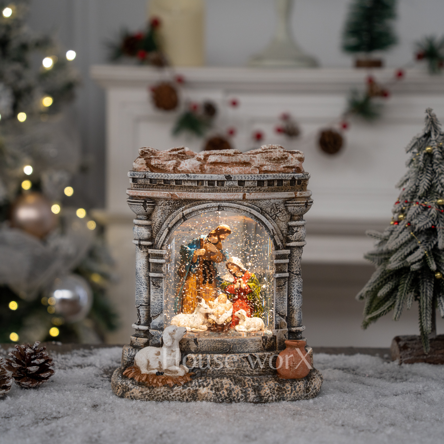 Decorative nativity scene in a snow globe with a festive background.