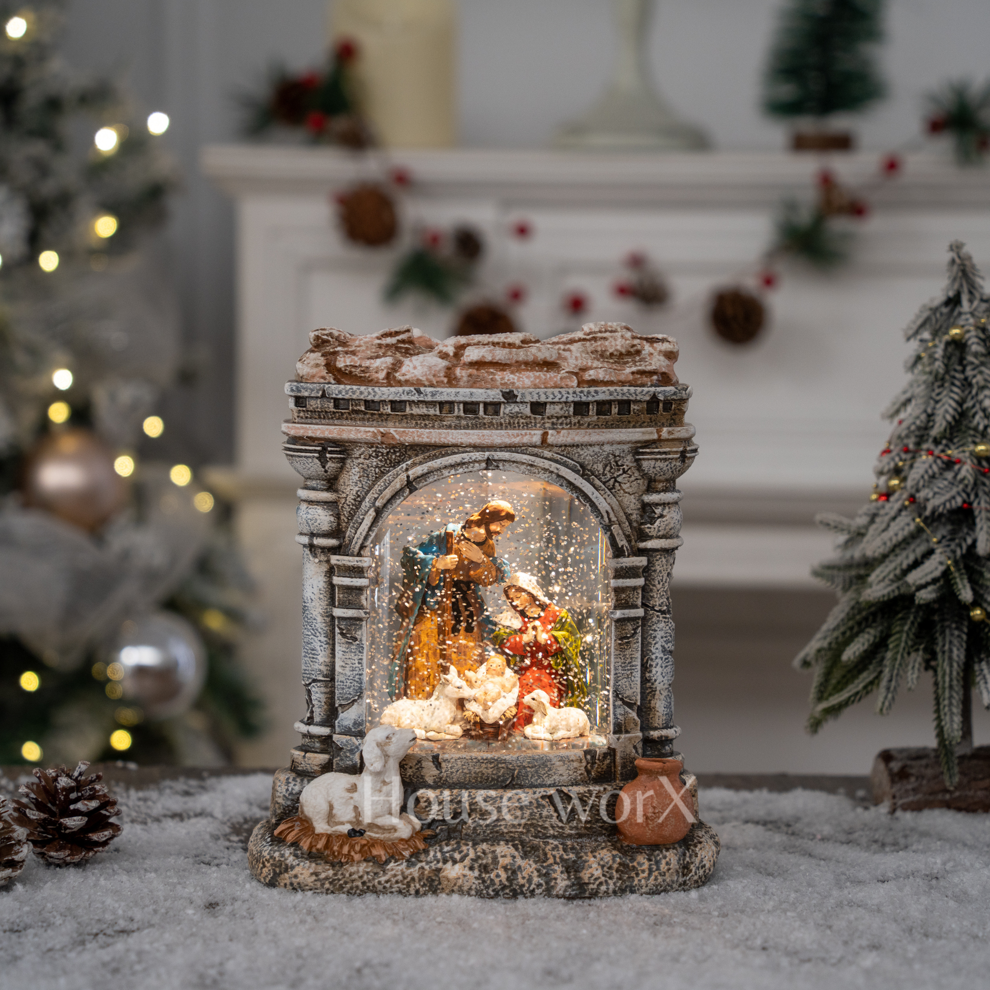 Decorative nativity scene in a snow globe with a festive background.