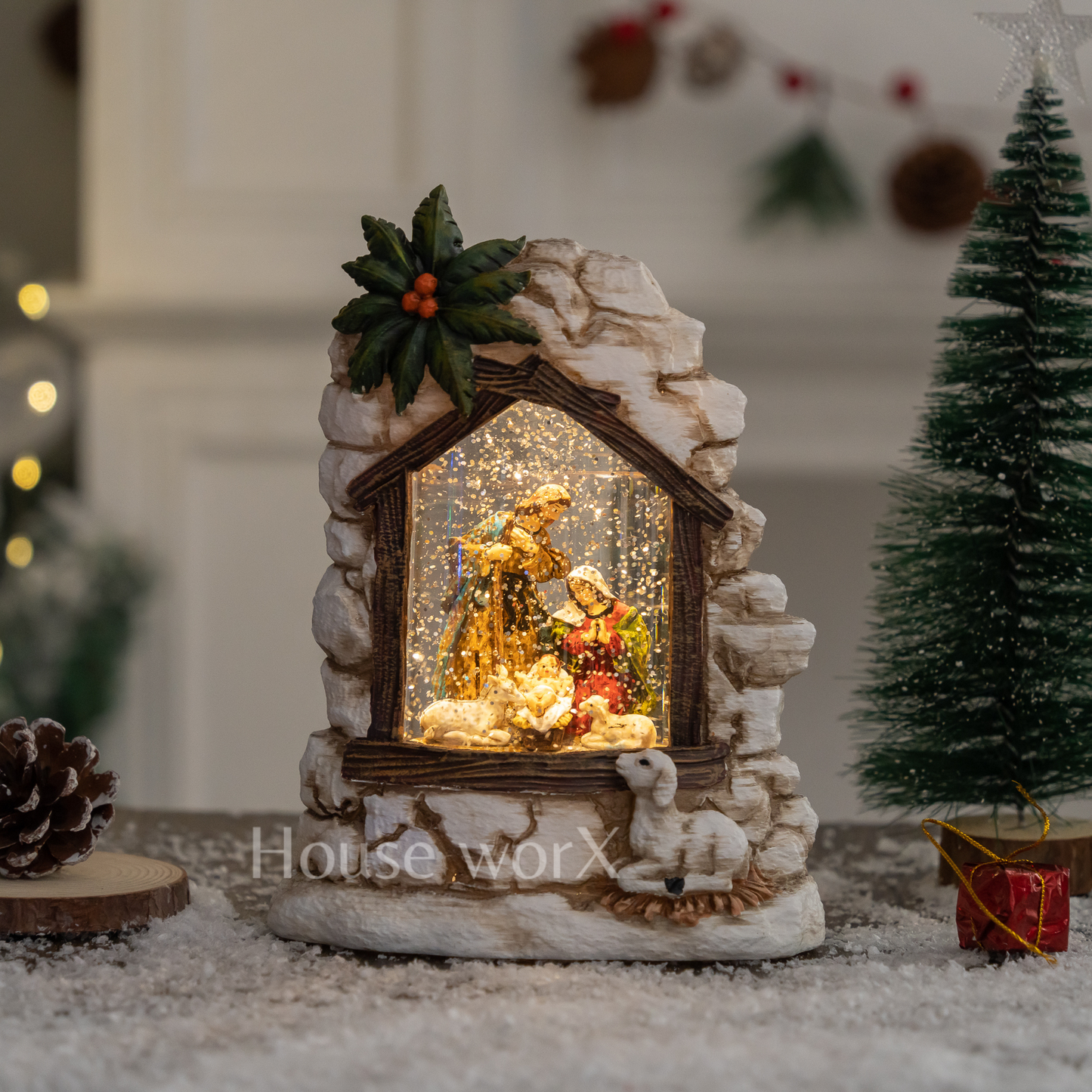 Decorative nativity scene in a stone enclosure with lights, surrounded by Christmas decorations. Snow Globe