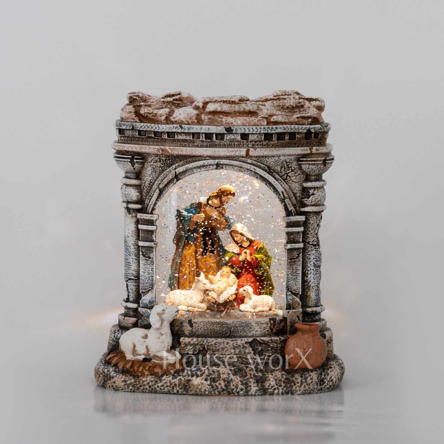 Decorative nativity scene with a rustic arch on a gray background Snow Globe