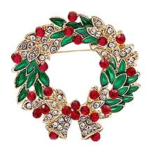 Christmas-themed brooch with green wreath, red berries, and gold accents on a white background