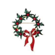 Christmas wreath brooch with red bow on a white background