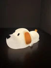 White dog-shaped object on a black surface