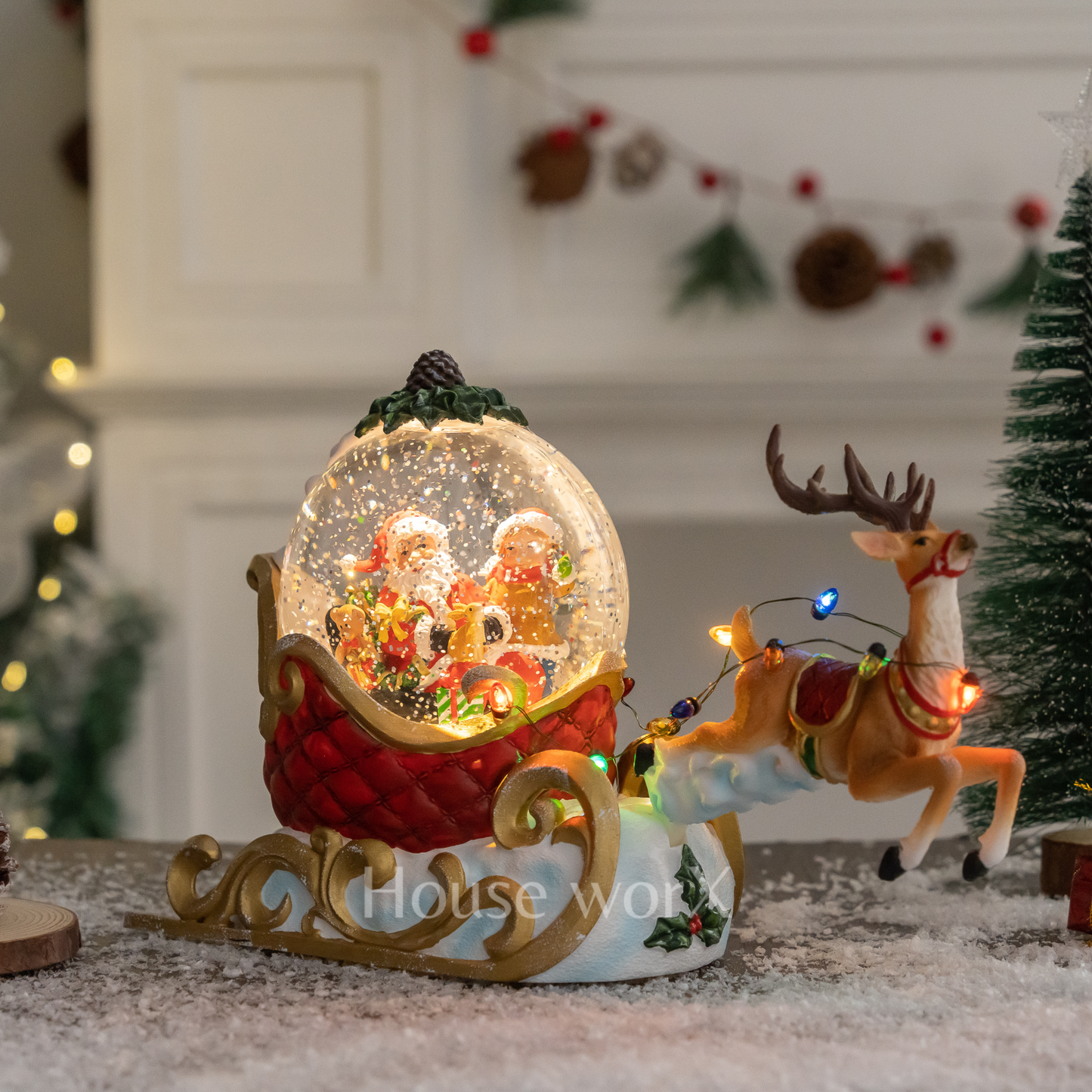 Decorative Christmas snow globe with Santa Claus and reindeer, surrounded by festive decorations.