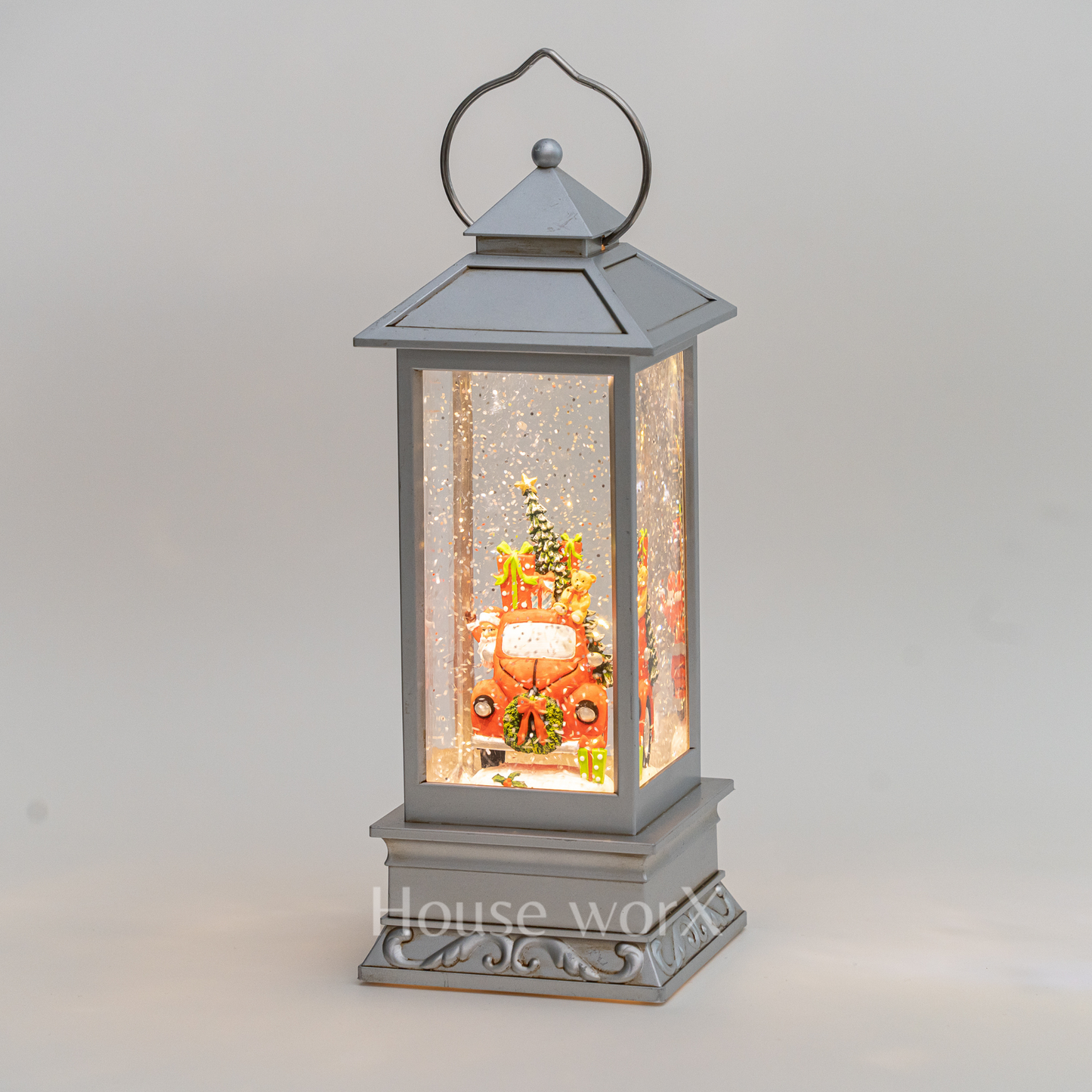 Decorative lantern with a Christmas scene inside on a gray background