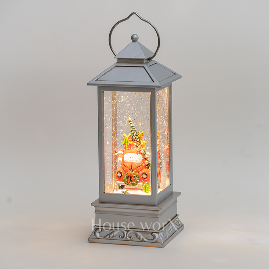 Decorative lantern with a Christmas scene inside on a gray background