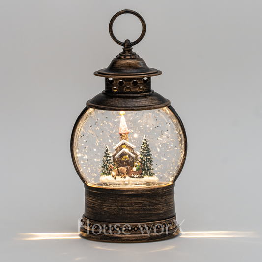 Decorative lantern with a snowy scene inside on a gray background