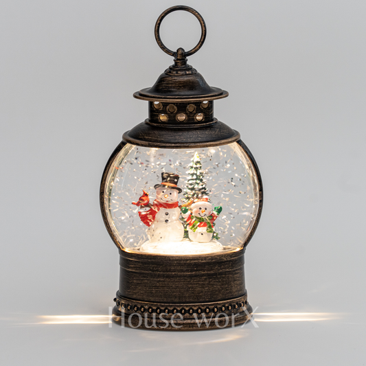 Decorative lantern with snowmen and a Christmas tree inside on a gray background