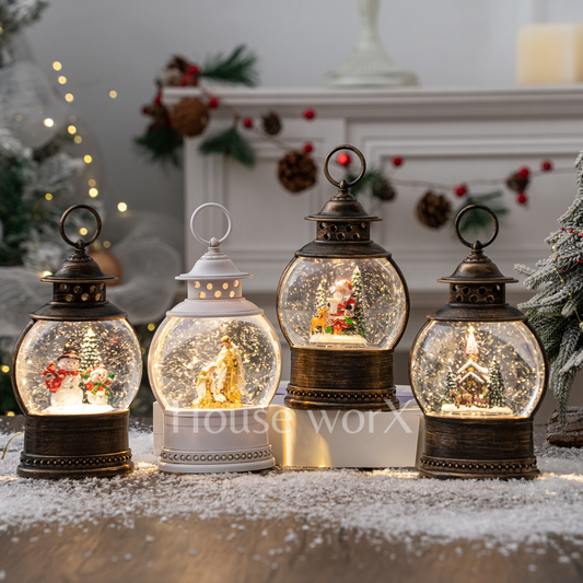 Set of decorative lanterns with snow globe effects featuring Christmas scenes, on a snowy surface.
