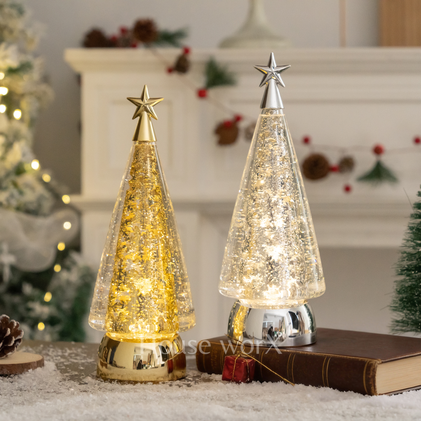 Two decorative Christmas tree lights on a surface with a festive background. snow globe